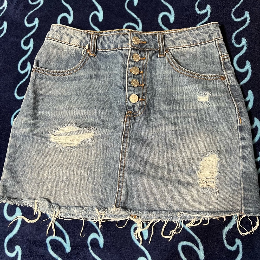 Distressed denim mini skirt.